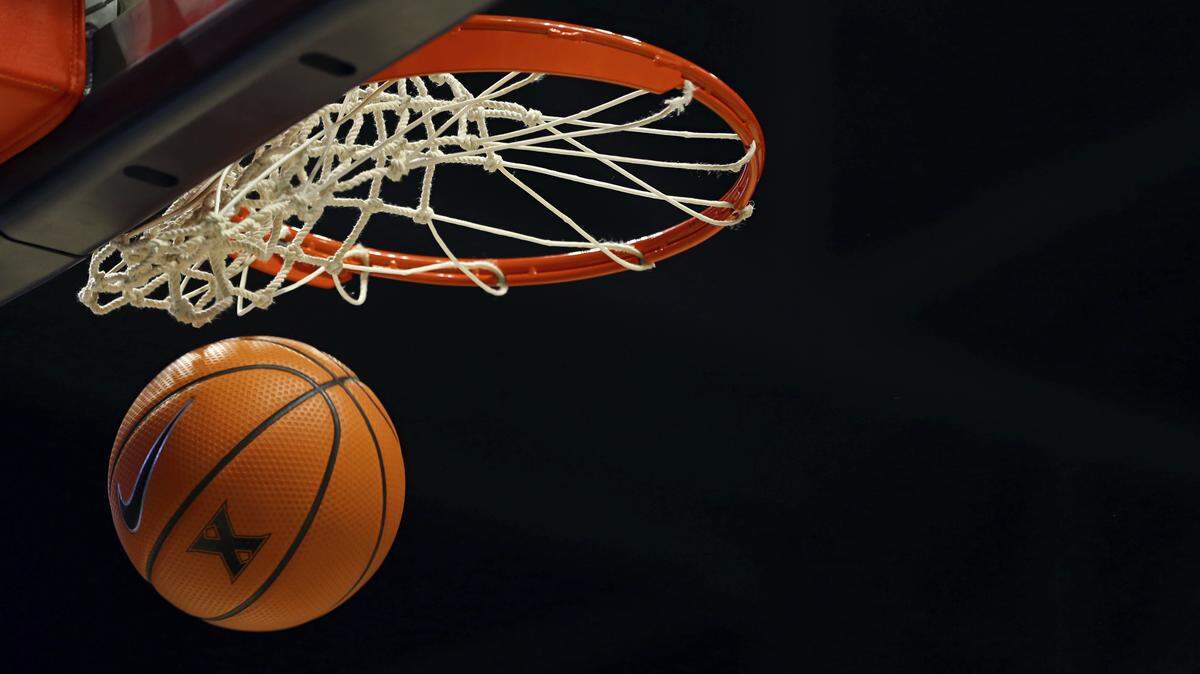A basketball goes through the net on a free throw during an NCAA college basketball game. Missouri triplets who play basketball at Dora High School are accused of swapping places for multiple free throws during a game last weekend that was caught on video — as well as earlier in the season, a parent said.