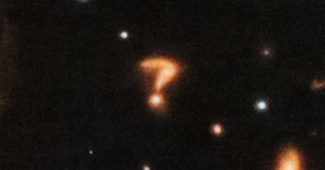 The cosmic question mark might be a pair of colliding galaxies, one expert said.