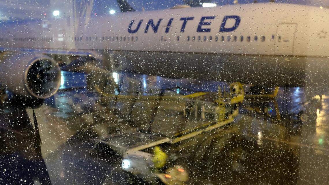 Rain drops cover the window as a United Airlines plane sits parked at a gate at Newark Liberty International Airport Wednesday, April 25, 2018, in Newark, N.J.