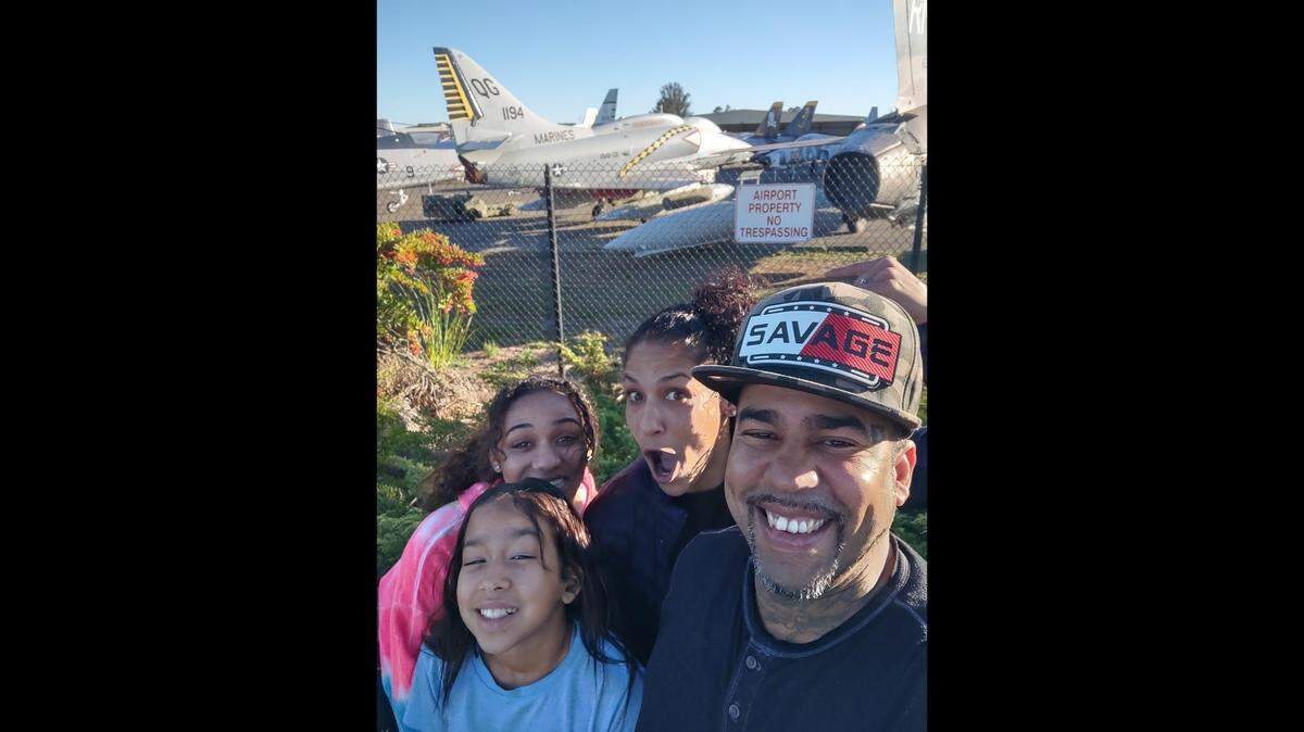 Jason Anglero-Wyrick with his three daughters. Anglero-Wyrick won $1.35 million in a settlement after a sheriff K-9 bit his leg and severely injured him in California, lawyers said.