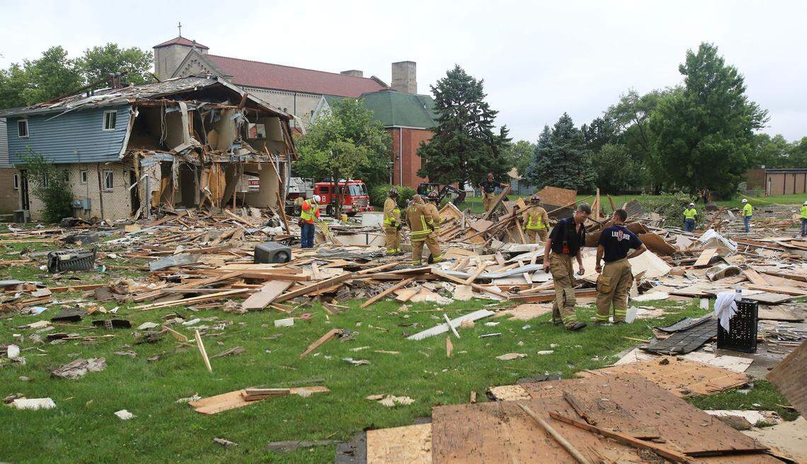 Firefigthers sort through the rubble after the blast. A cause for the explosion hasn't been determined, but fire officials said it may have been people stripping metal from a vacant home.