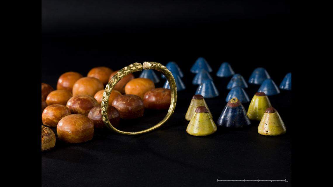 A gold bracelet and playing pieces were found in one of the ships, experts said.