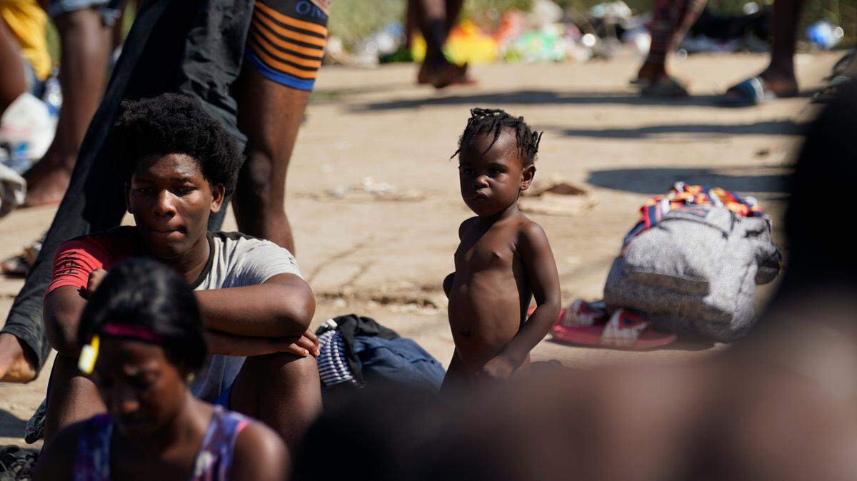 Migrants wait in a make-shift camp after crossing the Rio Grande to the United States from Mexico, Friday, Sept. 17, 2021, in Del Rio, Texas. Thousands of Haitian migrants have assembled under and around a bridge in Del Rio presenting the Biden administration with a fresh and immediate challenge as it tries to manage large numbers of asylum-seekers who have been reaching U.S. soil. (AP Photo/Eric Gay)