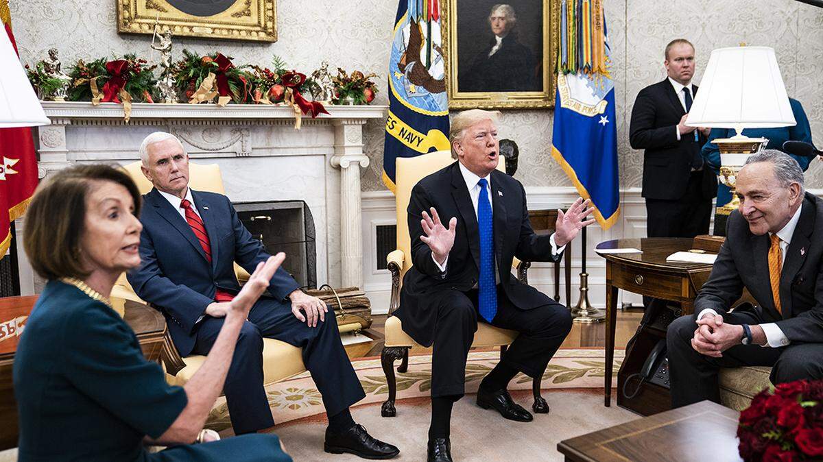 President Donald Trump debates with House Minority Leader Nancy Pelosi, D-Calif., left, and Senate Minority Leader Chuck Schumer, D-N.Y., right, as Vice President Mike Pence listens during a meeting in the Oval Office of White House on Dec. 11, 2018 in Washington, D.C. MUST CREDIT: Washington Post photo by Jabin Botsford
