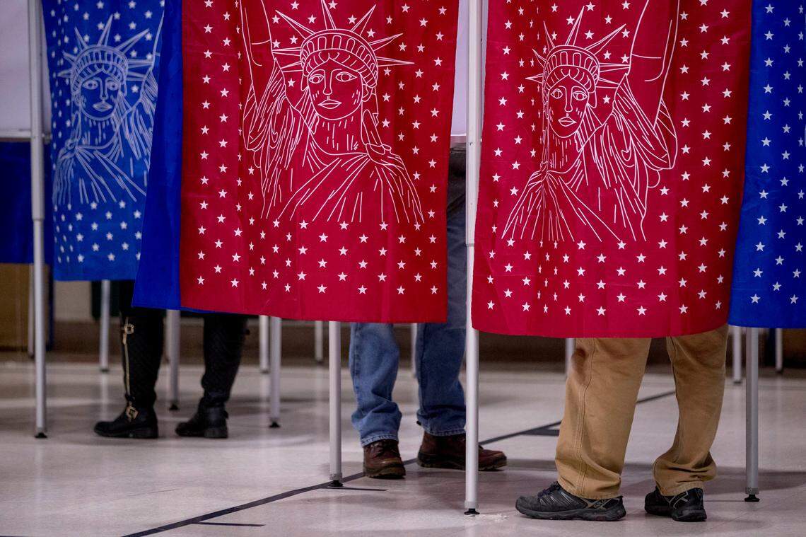 Residents stand in voting booths to vote in the New Hampshire Primary at Parker-Varney Elementary School, Tuesday, Feb. 11, 2020, in Manchester, N.H.