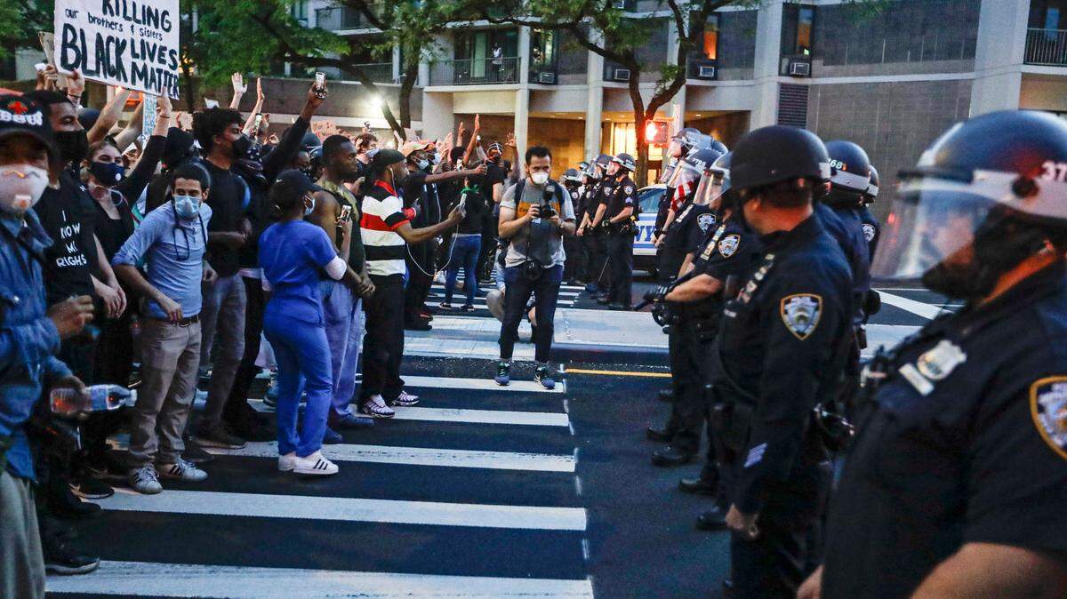 FILE- In this June 3, 2020 file photo, protesters confront New York Police officers as part of a solidarity rally calling for justice over the death of George Floyd, in the Brooklyn borough of New York. A New York woman was sentenced to six years in prison for throwing a Molotov cocktail at a police van during a demonstration protesting the murder of Floyd, officials said on Nov. 15, 2022. (AP Photo/Frank Franklin II)