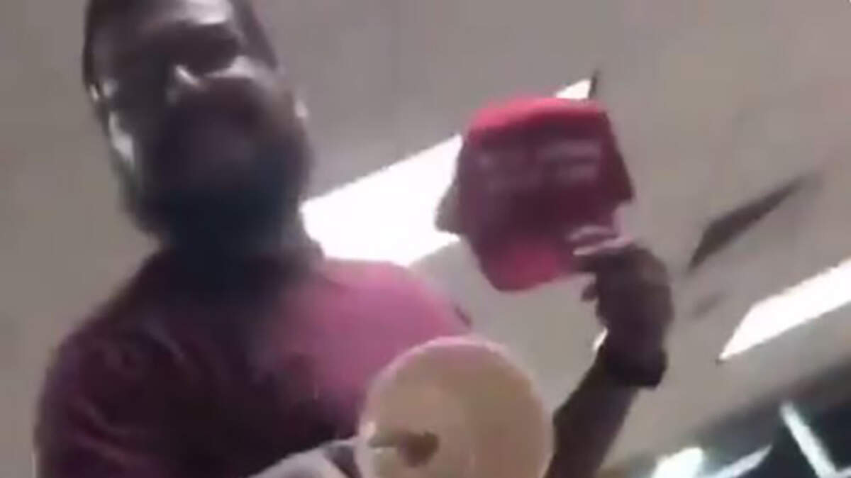 A man tossed a drink at a teen in a San Antonio Whataburger restaurant before stealing his "Make America Great Again" hat, video shows.