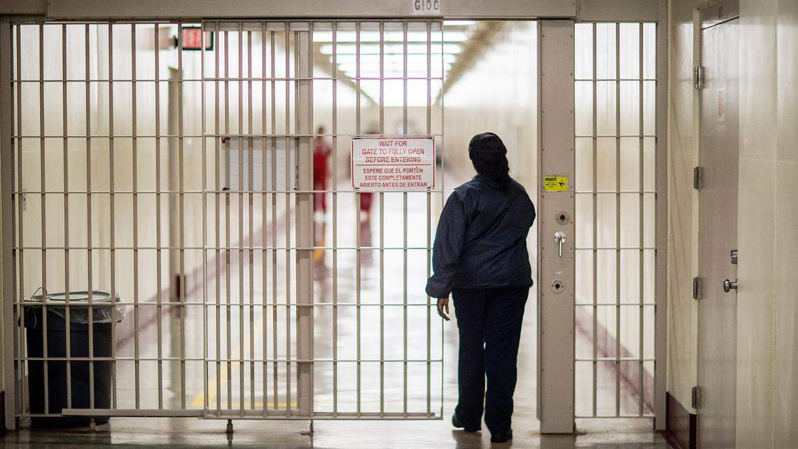 A detention officer walks through the halls at the Stewart Detention Center, Friday, Nov. 15, 2019, in Lumpkin, Ga. The number of COVID-19 cases within the facility surged amid the spread of the omicron variant, according to data released by Immigration and Customs Enforcement. (AP Photo/David Goldman)