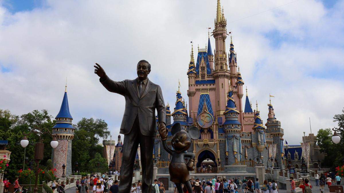 Two families began fighting over a photo opportunity at the entrance to Disney World’s Magic Kingdom, police said.