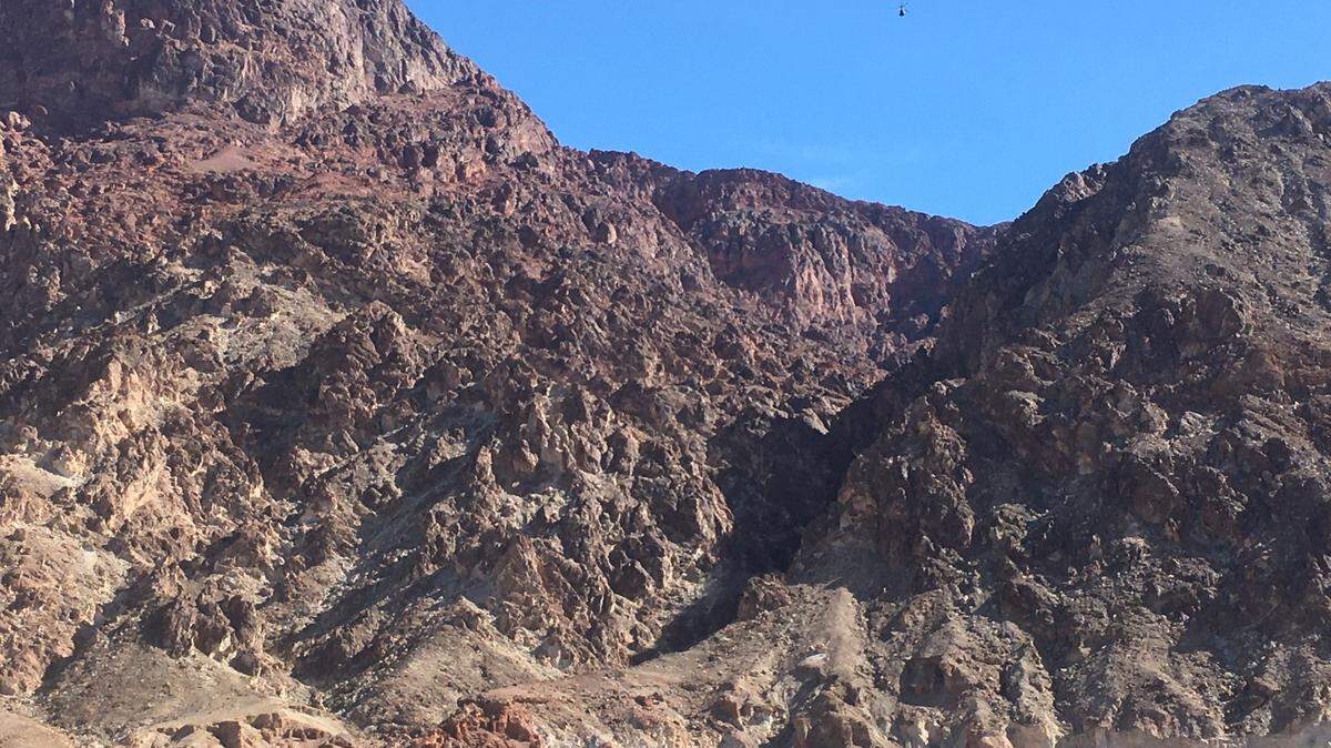 A climber died Saturday after stepping on a rock and triggering a rockslide that swept him past two others 95 feet in Deimos Canyon, Death Valley officials say.
