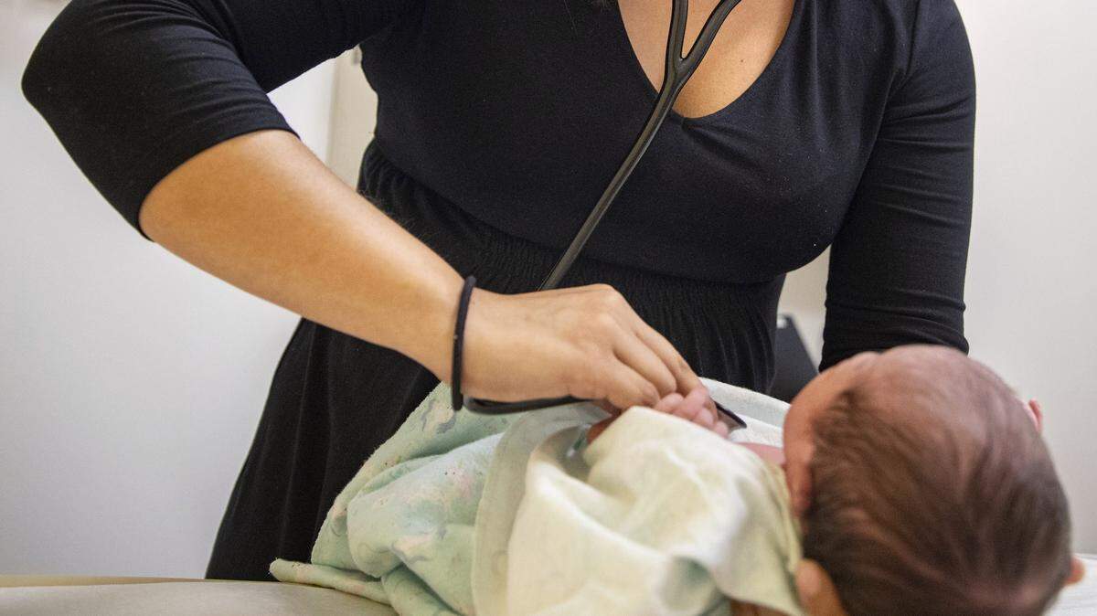 A pediatrician examines a newborn baby in her clinic in Chicago in August 2019. A new study from Australia might point to a cause for sudden infant death syndrome.