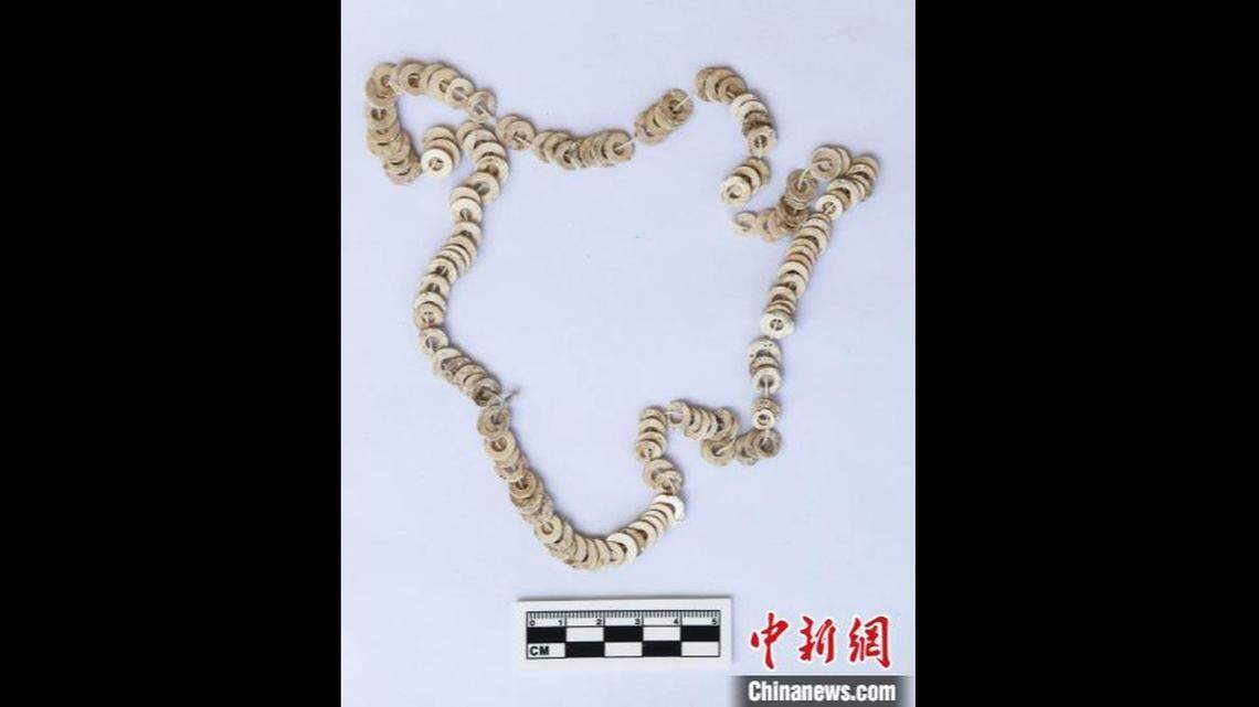 Experts unearthed this charm made of shells within at the site.