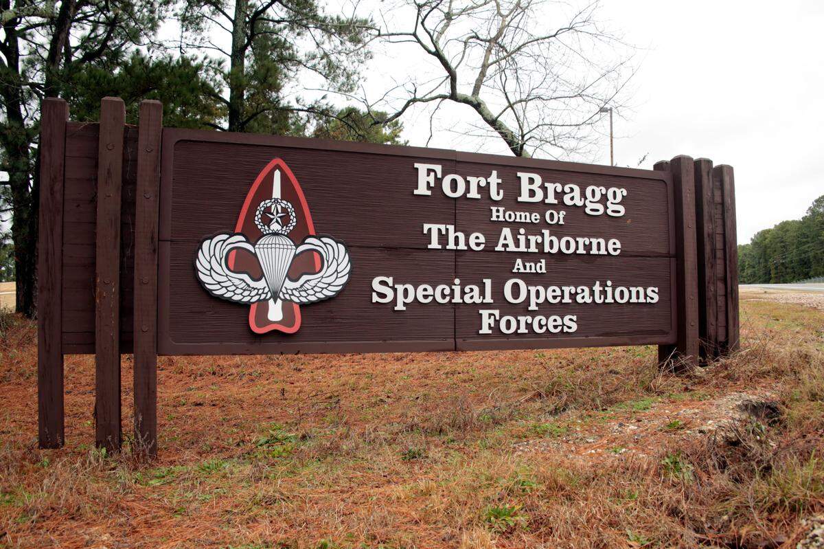 This Jan. 4, 2020 file photo shows a sign for at Fort Bragg, N.C. A Fort Bragg employee received hundreds of thousands of dollars in bribes in exchange for pushing maintenance contracts with the government, prosecutors said. Now, the man is sentenced to 42 months in prison.