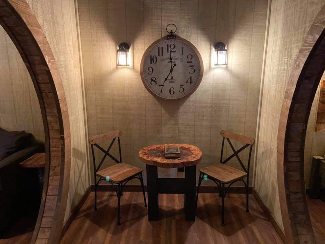 A dining nook with two chairs and a table separates the bedroom and living room.