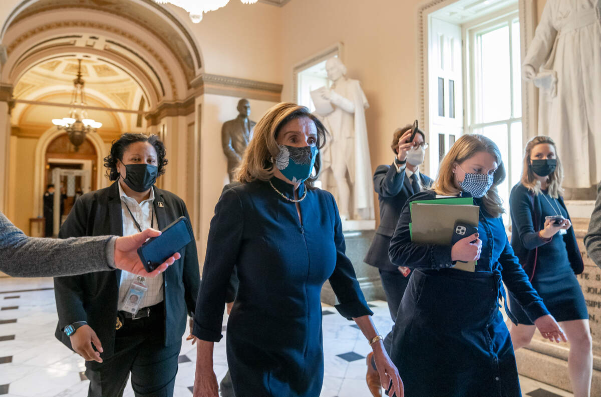 Speaker of the House Nancy Pelosi, D-Calif., returns to her leadership office after opening debate on the impeachment of President Donald Trump, at the Capitol in Washington, Wednesday, Jan. 13, 2021. The House of Representatives is pursuing an article of impeachment against Trump for his role in inciting an angry mob to storm the Capitol last week. (AP Photo/J. Scott Applewhite)