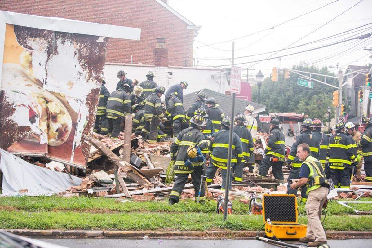 Firefigthers in Hamilton, New Jersey, sift through rubble after a deadly house collapse Monday morning.
