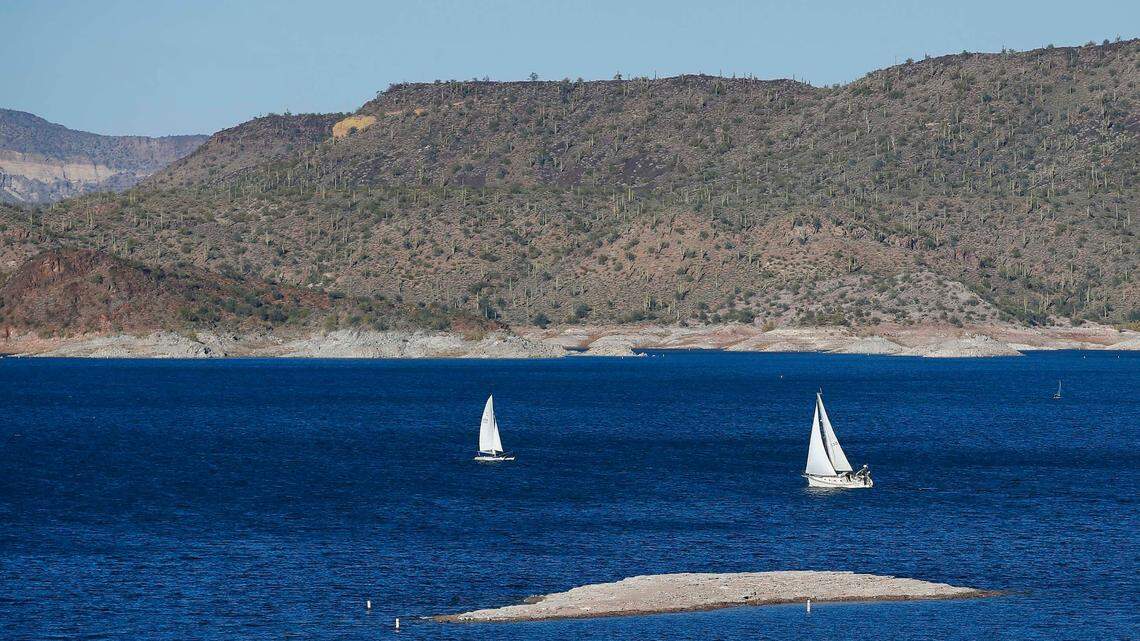 Sailboats navigate the drought-lowered waters at Lake Pleasant Sunday, Nov. 23, 2014, in Peoria, Ariz. A 20-year-old swimmer was found dead in the lake on April 24, 2022 after disappearing in the water. (AP Photo/Ross D. Franklin)