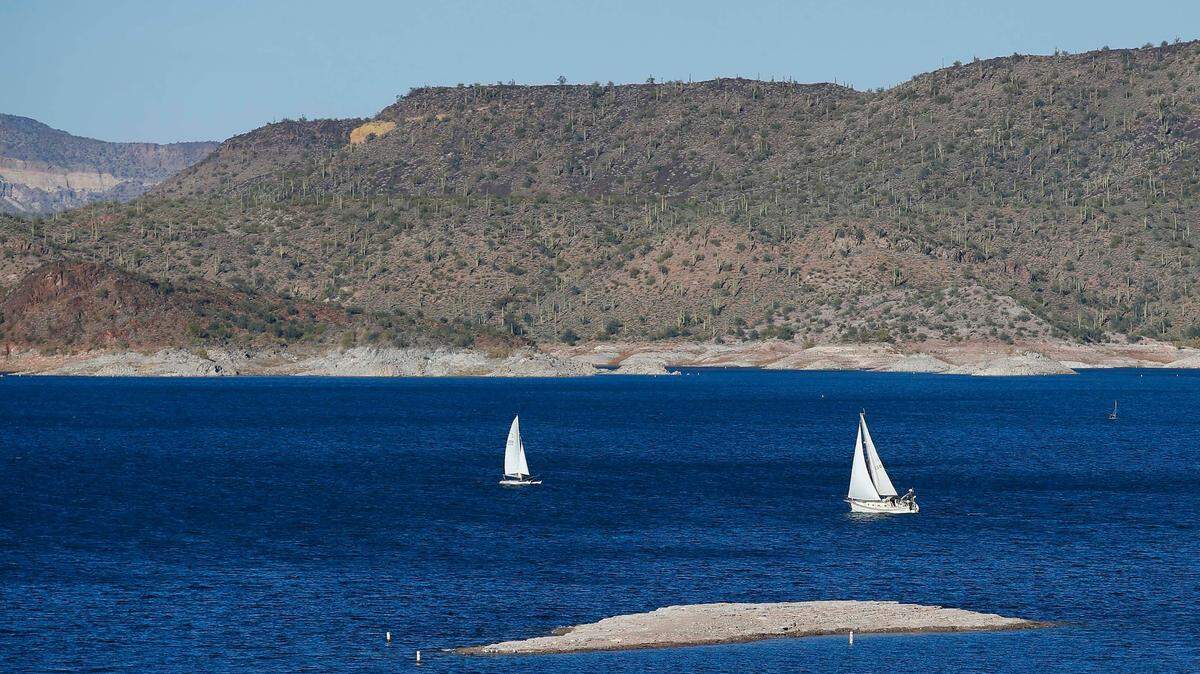 Sailboats navigate the drought-lowered waters at Lake Pleasant Sunday, Nov. 23, 2014, in Peoria, Ariz. A 20-year-old swimmer was found dead in the lake on April 24, 2022 after disappearing in the water. (AP Photo/Ross D. Franklin)