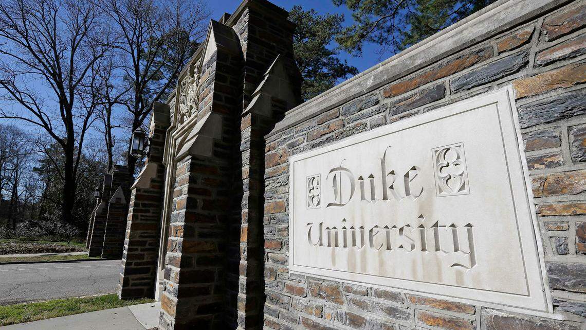 This Jan. 28, 2019, file photo shows the entrance to the main Duke University campus in Durham, N.C. A former employee of Duke University Health System is suing the university after he says he was fired after he reported discriminatory and racist comments made by his supervisor, according to a lawsuit.