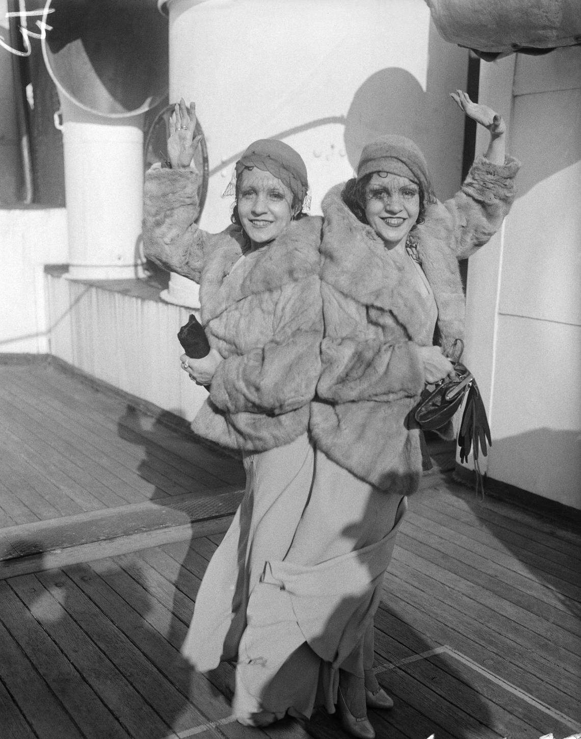 Violet and Daisy Hilton, conjoined twins, are pictured upon their arrival in New York, Oct. 6, 1933, aboard the Aquitania. (AP Photo)