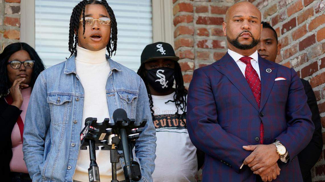 FedEx driver D’Monterrio Gibson, left, stands with family members and one of his attorneys, Carlos Moore, right, as he speaks at a news conference in Ridgeland, Miss., on Feb. 10, 2022.