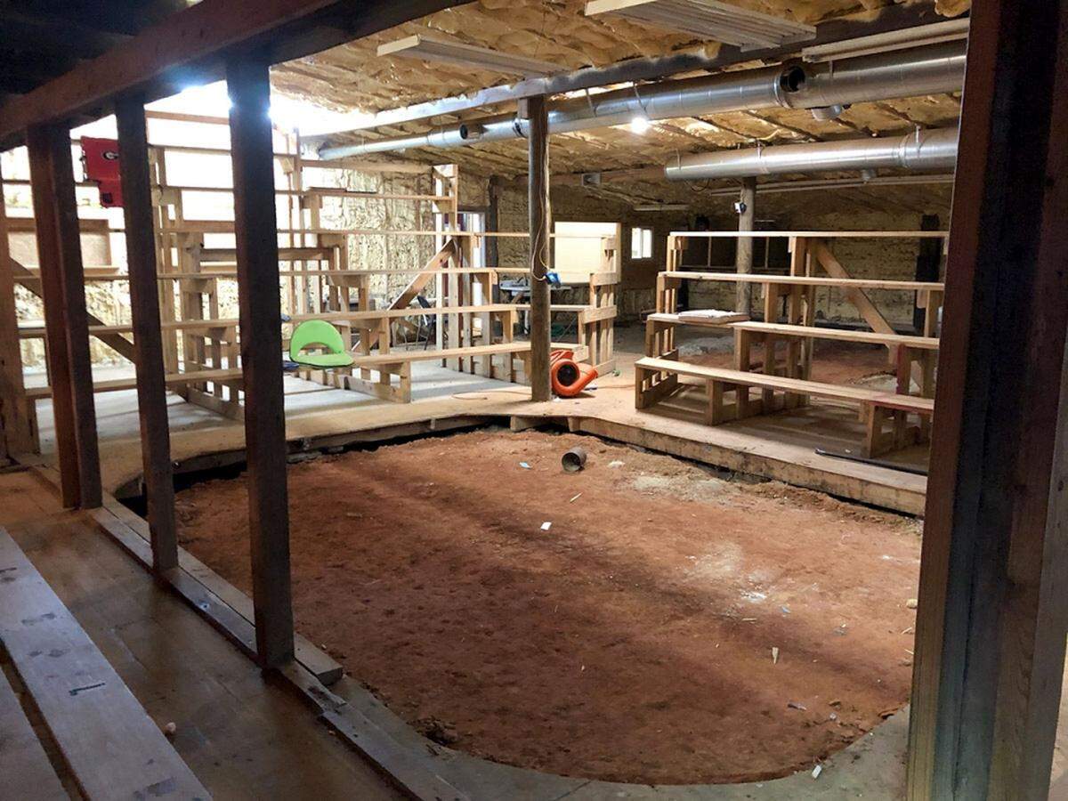 Animal fighting ring inside The Red Barn in Swainsboro, Ga., surrounded by stadium-style bleacher seating.