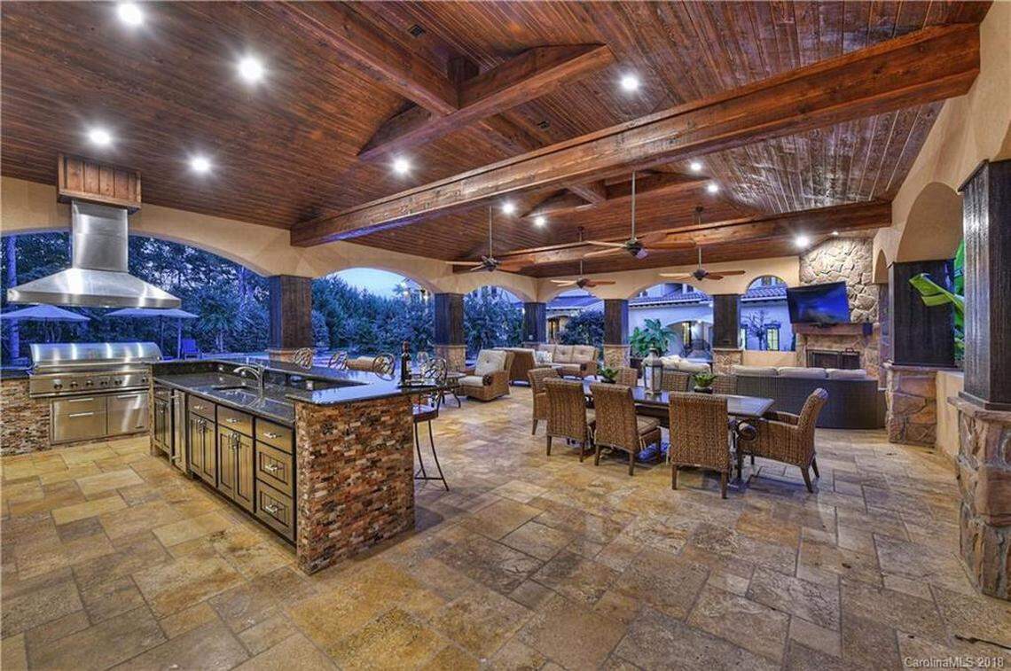 The mansion has a 1,900-square-foot terrace with a stone fireplace, kitchen and guest quarters.