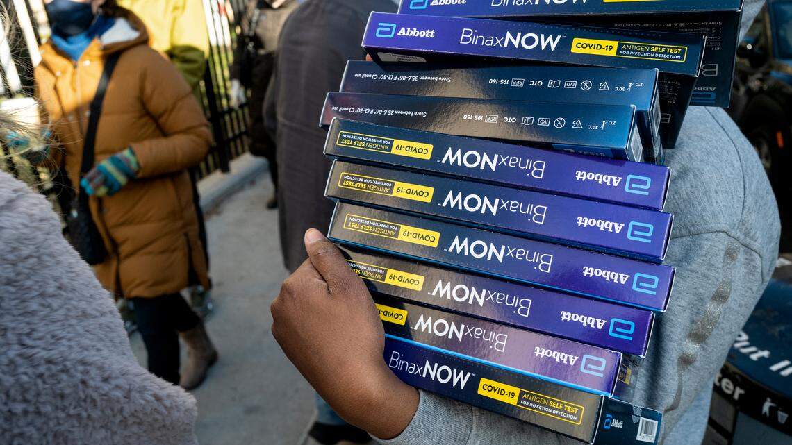 People line up to receive test kits to detect COVID-19 as they are distributed in the Lower East Side neighborhood in the Manhattan borough of New York Thursday, Dec. 23, 2021. A Brooklyn woman pleaded guilty to selling fabricated COVID-19 test results, among other charges, according to officials. (AP Photo/Craig Ruttle)