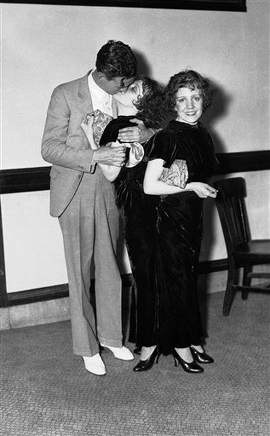 Maurice L. Lambert of Keyser, W. Va., kisses his finacee Violet Hilton, as they pose with her Siamese Twin sister, Daisy Hilton in New York, July 5, 1934. Maurice and Violet were denied a marriage license when the New York City Corporation Counsel declared that it is illegal to issue a marriage license to “two persons.” Usually calm about such things, the City of New York completely flip-flopped on the matter. (AP Photo)