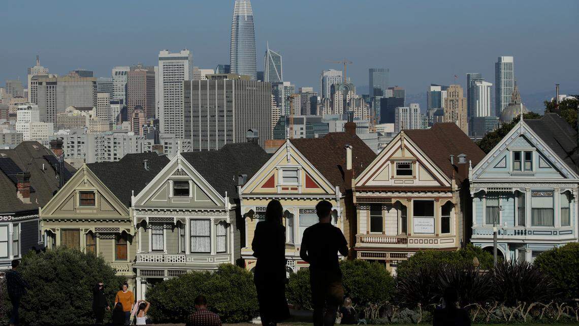 FILE - In this Feb. 26, 2020, file photo, visitors look toward the “Painted Ladies,” a row of historical Victorian homes, in front of the San Francisco skyline from Alamo Square Park in San Francisco. In March 2022, a street in the city was unofficially renamed to show support for Ukraine.
