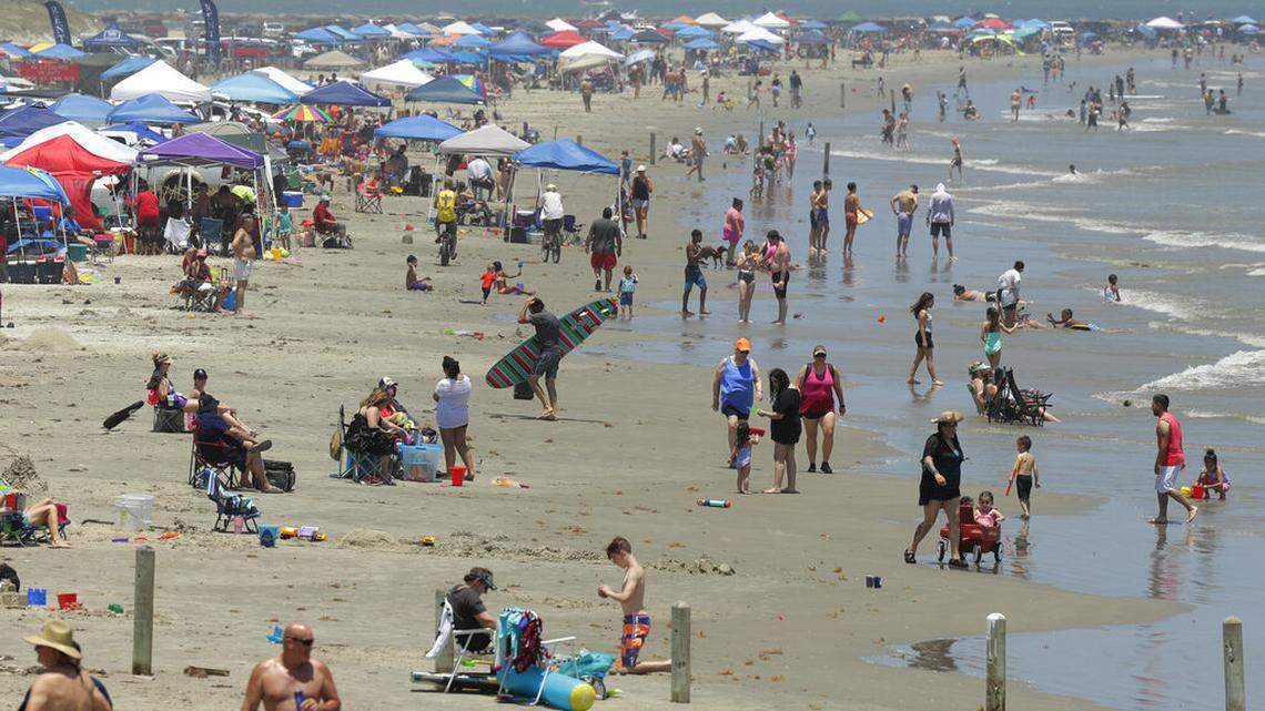 FILE - In this May 23, 2020 file photo, people gather on the beach in Port Aransas, Texas. (AP Photo/Eric Gay, File)