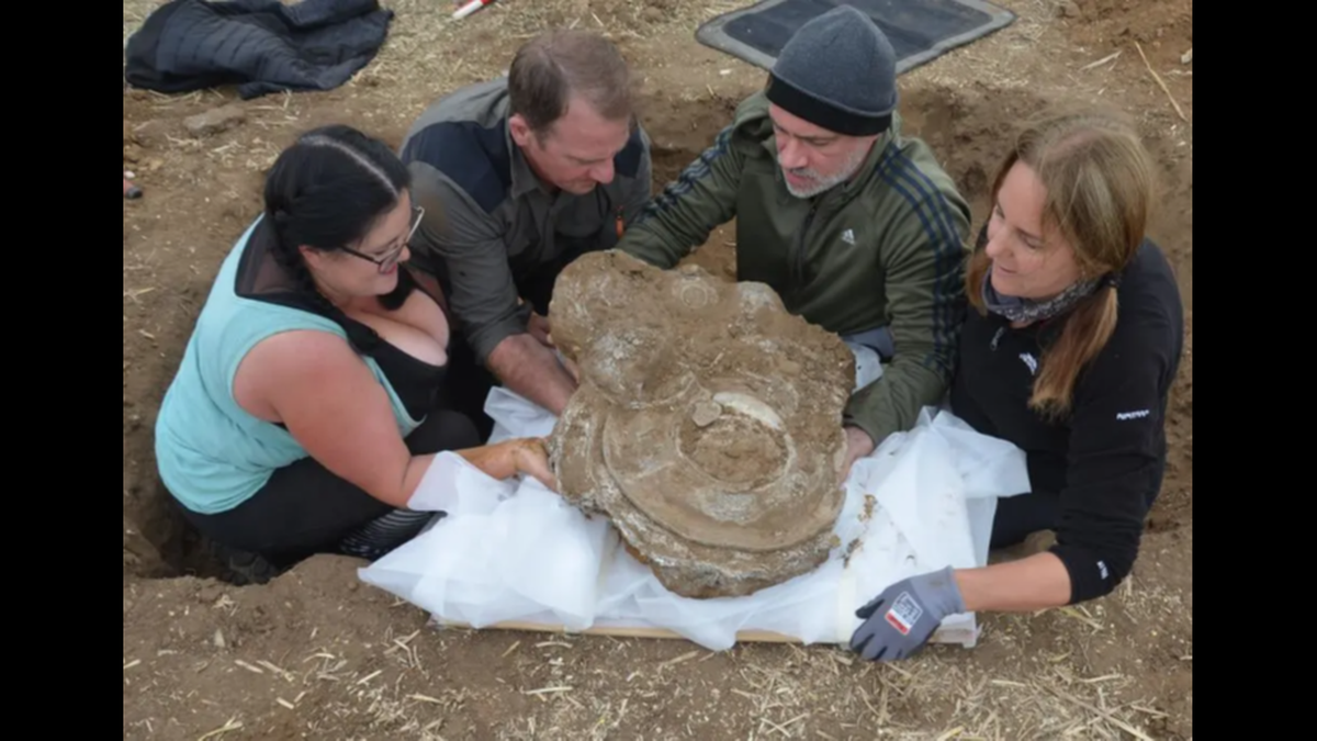 The pieces were stacked together in the pit, likely placed there for safekeeping or as an offering, officials said.