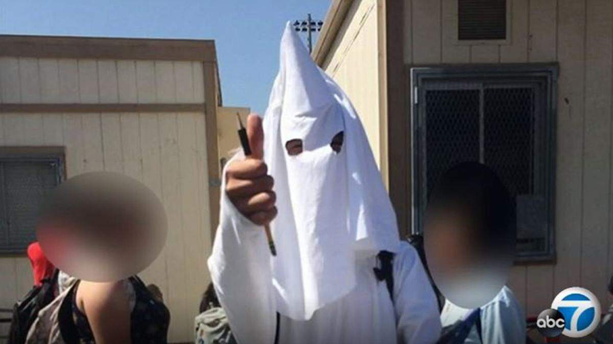A high school student wore the KKK costume throughout the school day after his history project on a Klan leader was reportedly approved by his history teacher.