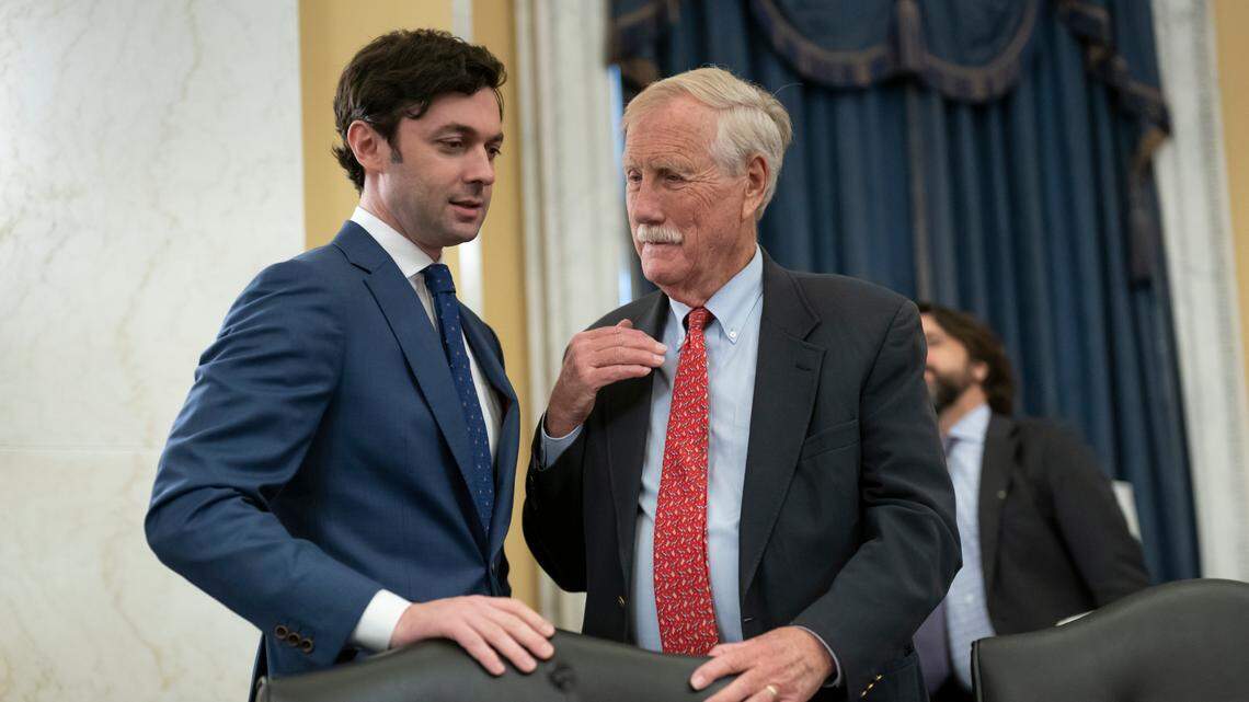Sen. Jon Ossoff, D-Ga., left, confers with Sen. Angus King, I-Maine, as Senate Rules Committee meets on the Electoral Count Reform and Presidential Transition Improvement Act, at the Capitol in Washington, Tuesday, Sept. 27, 2022. (AP Photo/J. Scott Applewhite)