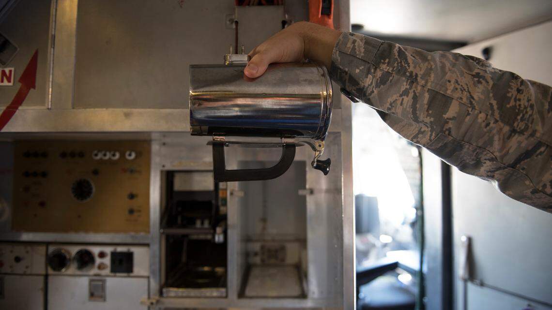 A Travis Air Force Base airman holds a hot cup, which is easily broken and costs more than $1,000 to replace. The base said it’s working on developing a more affordable replacement for the fragile handles.