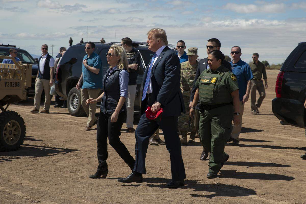 President Donald Trump walks with Homeland Security Secretary Kirstjen Nielsen as they visit a newly constructed part of a border wall with Mexico in Calexico, Calif., Friday April 5, 2019. (AP Photo/Jacquelyn Martin)