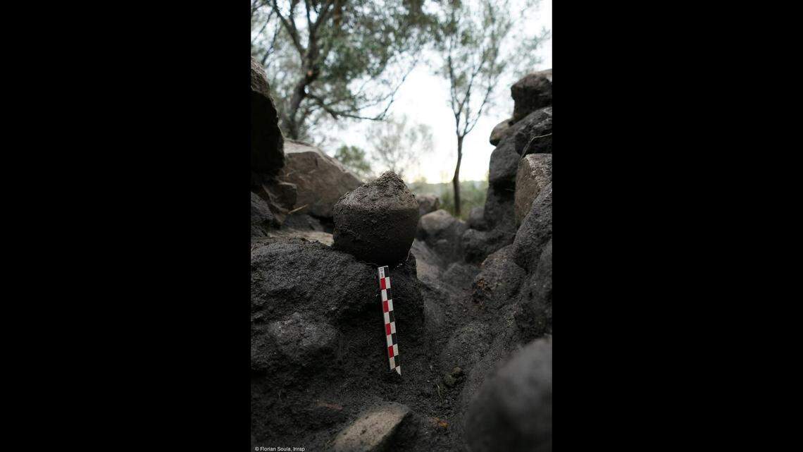 A pear-shaped vase was among several vases discovered on a paving inside the wall of the terraced structure, according to INRAP.