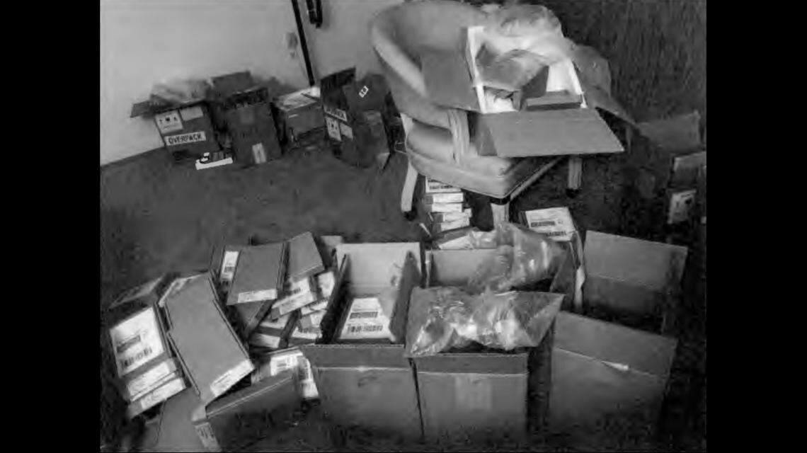 Investigators said they found this photo on one of the suspect’s phones, showing “approximately seven cardboard shipping boxes with the labels and markings used by Apple to return phones that have been submitted for warranty claims but rejected for being counterfeit or otherwise out of warranty.”