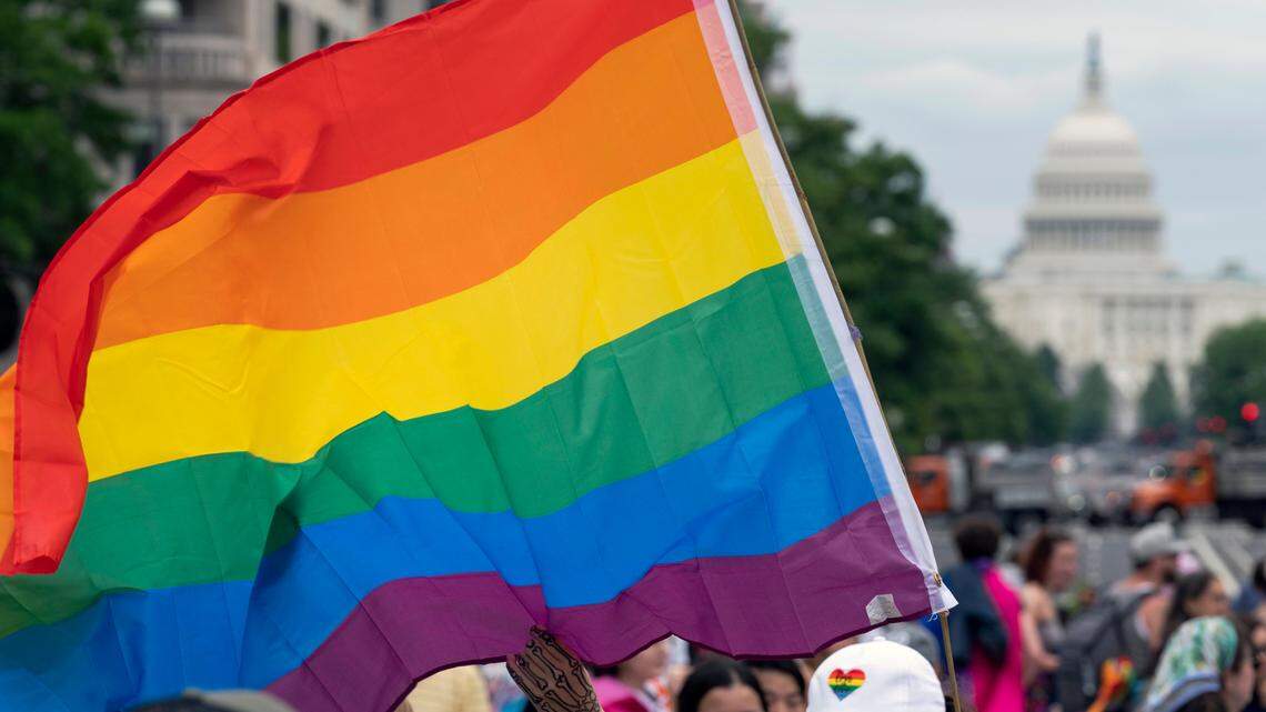 With the U.S. Capitol in the background, a person waves a rainbow flag as they participate in a rally in support of the LGBTQIA+ community at Freedom Plaza, Saturday, June 12, 2021, in Washington. The U.S. Senate is expected to vote on same-sex marriage legislation in the coming weeks. (AP Photo/Jose Luis Magana, File)