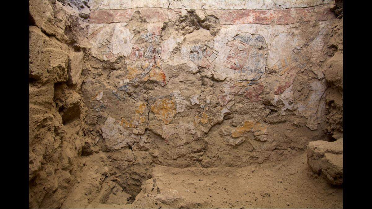 Two seated women display colorful threads and spinning or weaving tools in the lower part of the same inner wall, according to the team.
