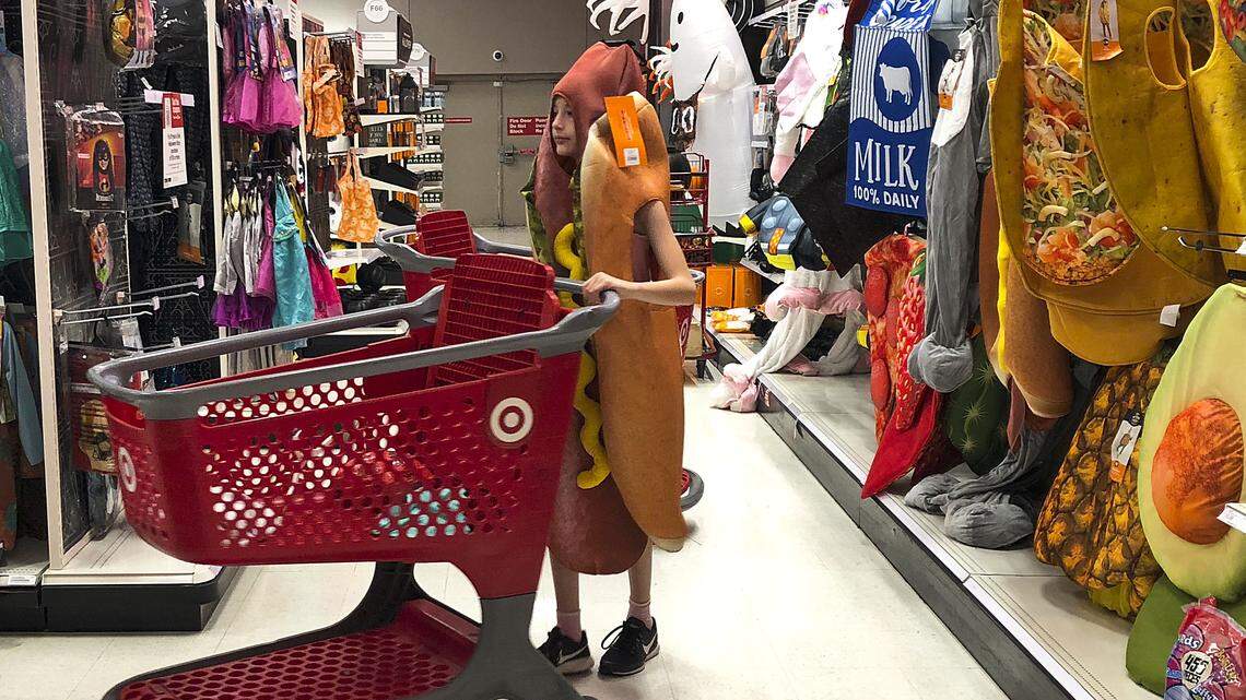 A young customer walks through the Target aisles wearing a hotdog costume in Aventura, Florida.
