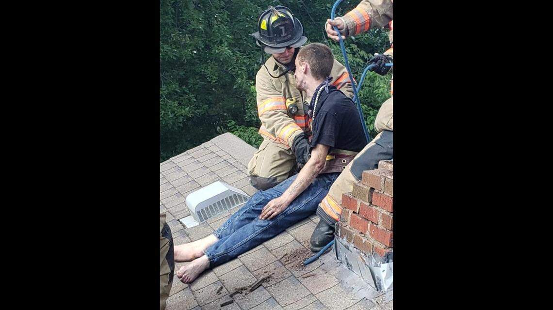 A barefoot Cody Methanial Sargent sits atop a house after trying to escape police through a chimney. Photo from Vanderburgh County Sheriff’s Office.