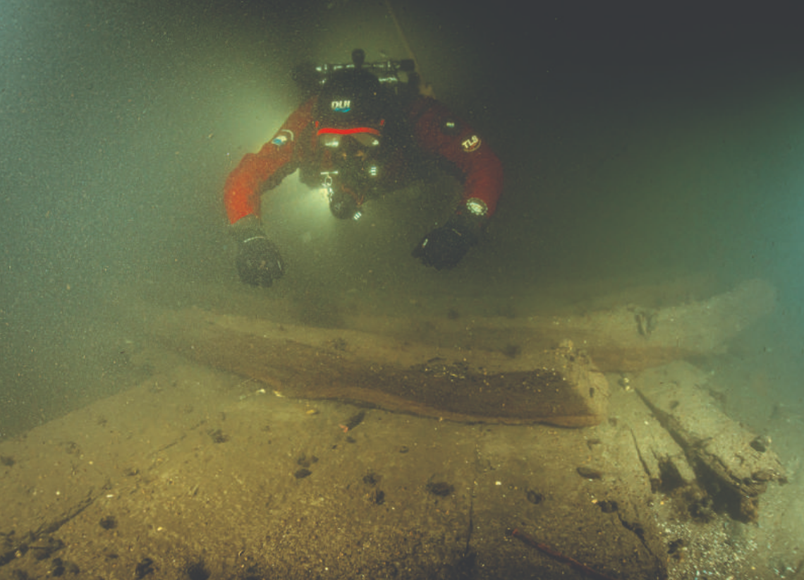 A diver explores the wreck at the bottom of the river