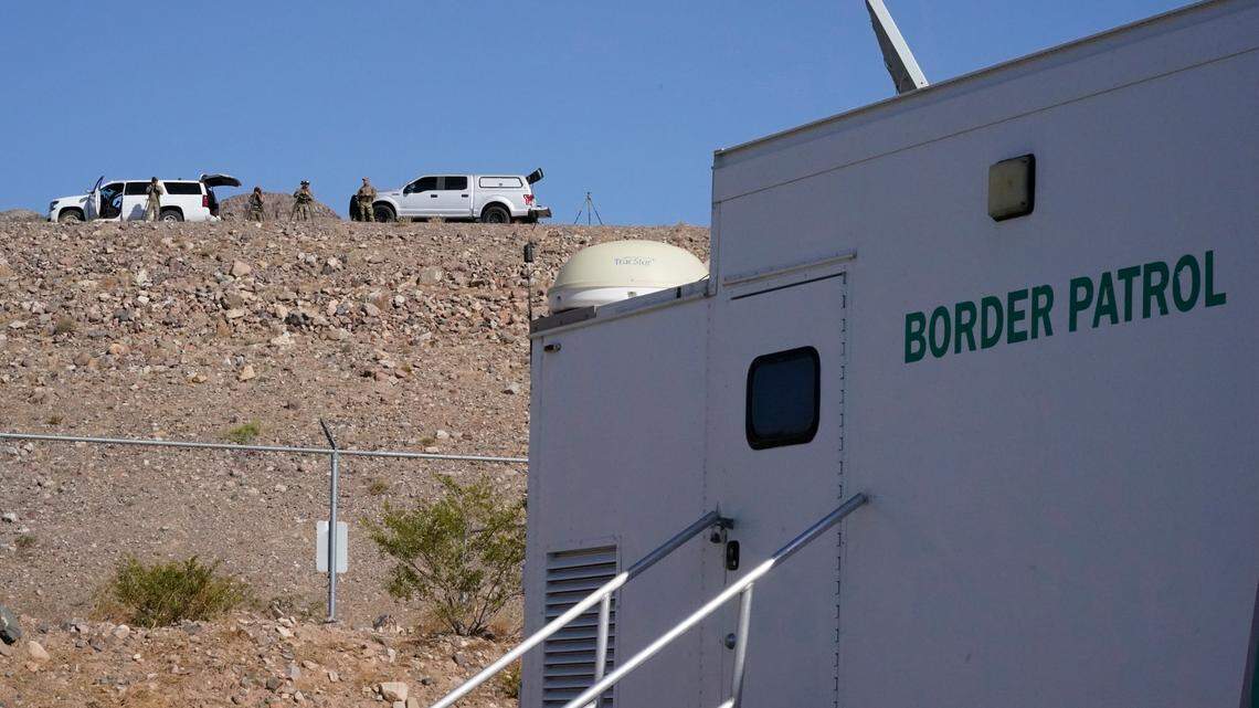 Members of the Border Patrol Tactical Team keep watch by the U.S. Customs and Border Protection Central Processing Center, Friday, June 25, 2021, in El Paso, Texas. (AP Photo/Jacquelyn Martin)