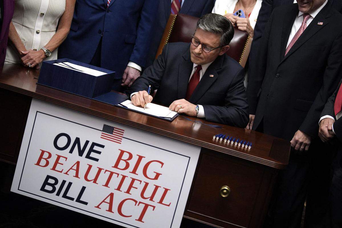 House Speaker Mike Johnson, joined by Republican leaders, signs President Donald Trump’s One Big Beautiful Bill Act on Capitol Hill on July 3, 2025. The bill makes permanent President Donald Trump’s 2017 tax cuts, increase spending on defense and immigration enforcement and temporarily cut taxes on tips, while at the same time cutting funding for Medicaid, food assistance for the poor, clean energy and raises the nation’s debit limit by $5 trillion.