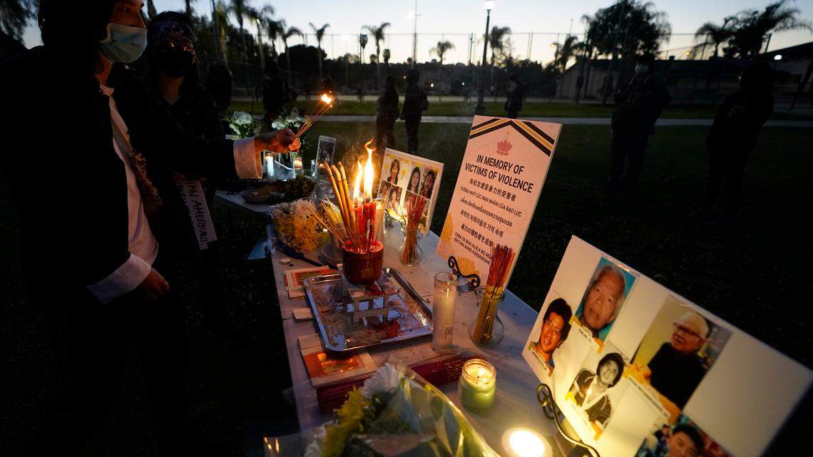 People pay theirs respects at a memorial in honor of the victims of the shootings in Atlanta, where eight people were killed the week before, during a candle vigil in Monterrey Park, Calif., late Saturday, March 27, 2021. The shootings at three Georgia massage parlors and spas that left eight people dead, six of them women of Asian descent, come on the heels of a recent wave of attacks against Asian Americans since the coronavirus entered the United States. (AP Photo/Damian Dovarganes)