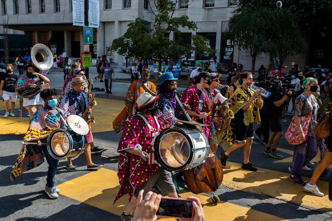 A band from New York and Philadelphia area plays as they march at Black Lives Matter Plaza near the White House in Washington, to join other marchers during the March on Washington, Friday, Aug. 28, 2020, commemorating the 57th anniversary of the Rev. Martin Luther King Jr.’s “I Have A Dream” speech. (AP Photo/Manuel Balce Ceneta)