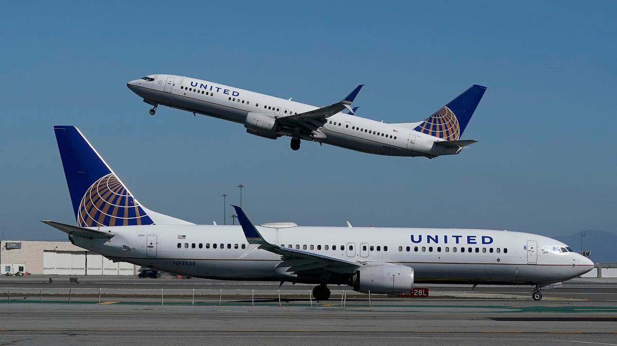 FILE - In this Oct. 15, 2020, file photo, a United Airlines airplane takes off over a plane on the runway at San Francisco International Airport in San Francisco. (AP Photo/Jeff Chiu, File)