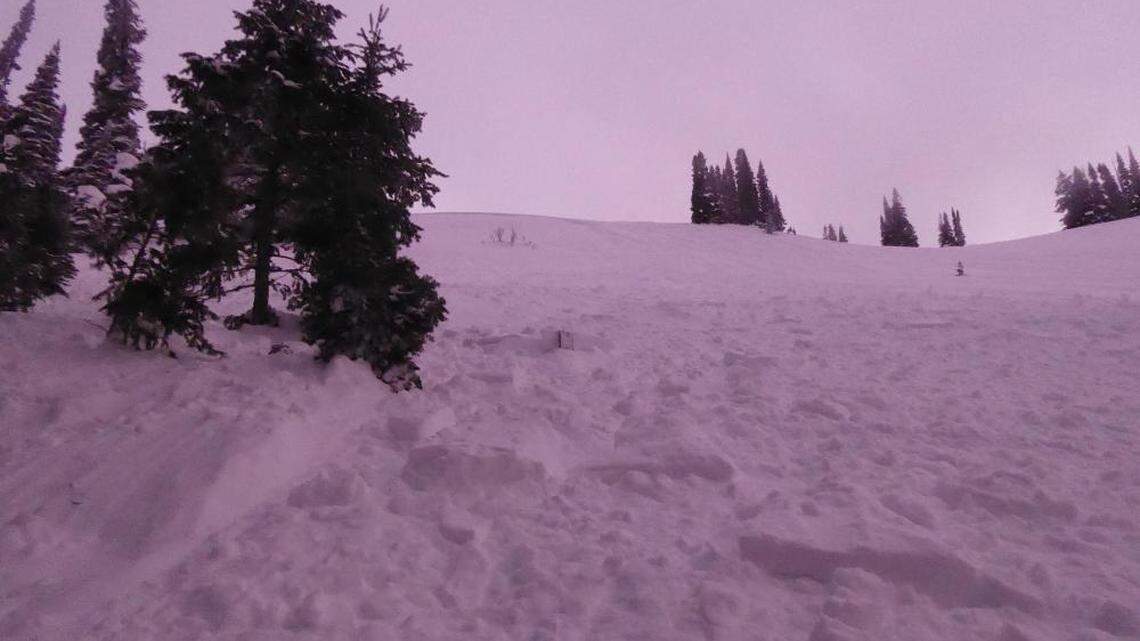 A snowmobiler was caught in an avalanche near West Yellowstone, Montana, officials said.