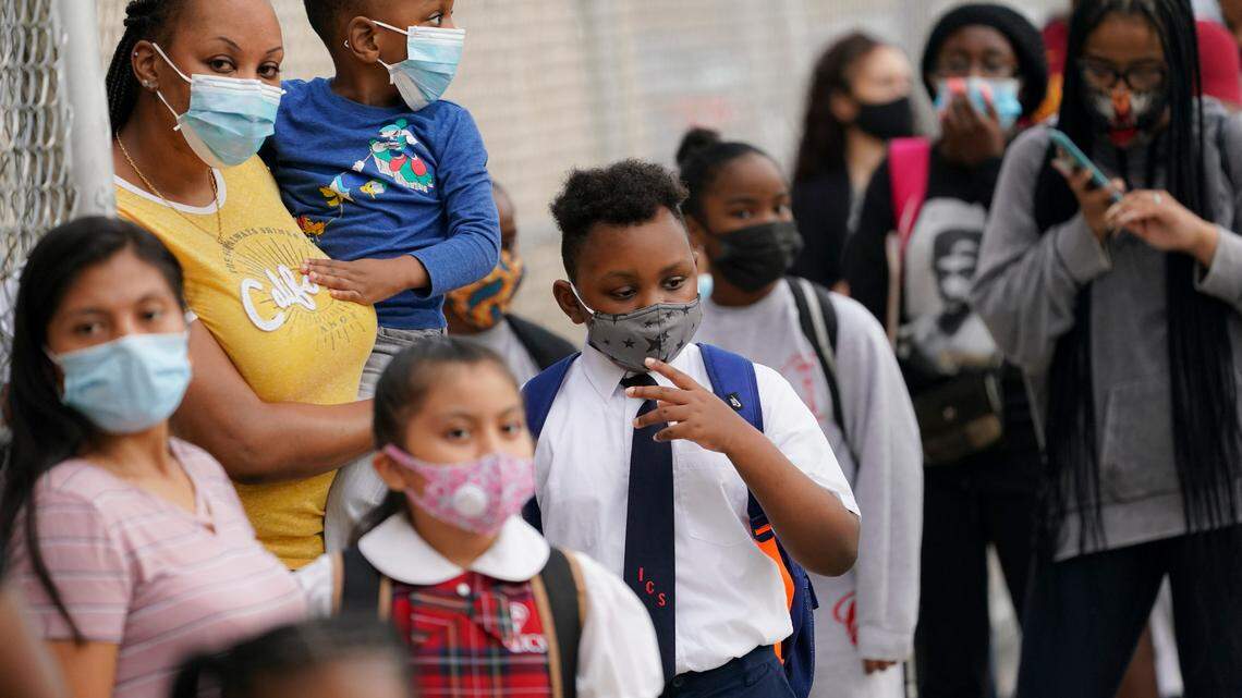 Students wear protective masks as they arrive for classes at the Immaculate Conception School while observing COVID-19 prevention protocols in The Bronx borough of New York.